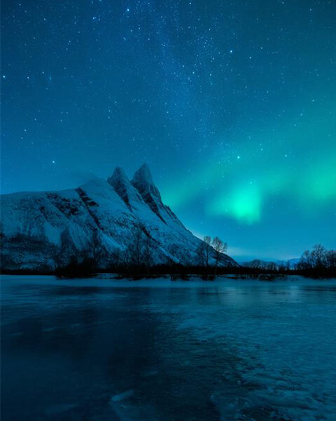 Mountain landscape under the Northern Lights